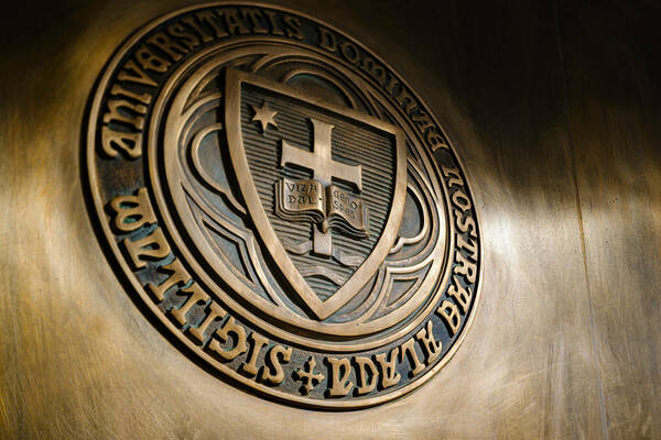 University seal on a metal door at the Theodore Hesburgh Library